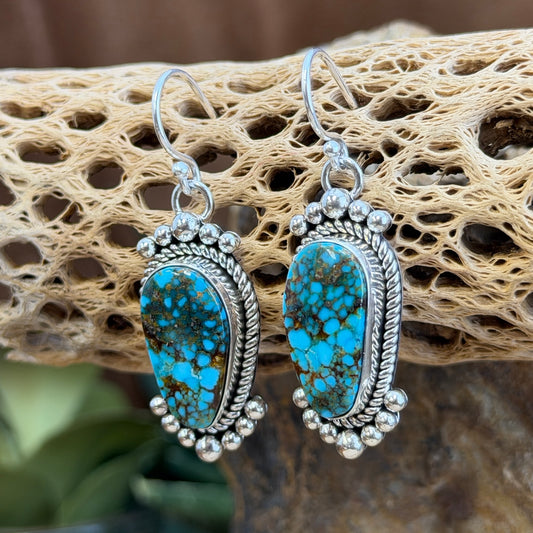 Kingman Turquoise Dangle Earrings by Artie Yellowhorse - styled view on cholla cactus showing full earring profile