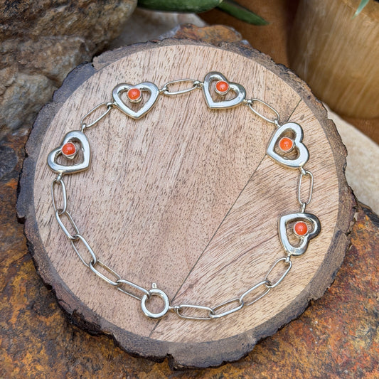 Full length of sterling silver coral heart link bracelet