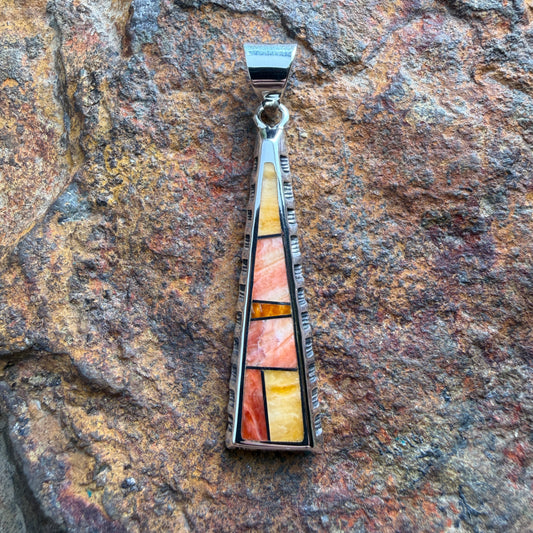 various orange stone pendant on a triangular pendant