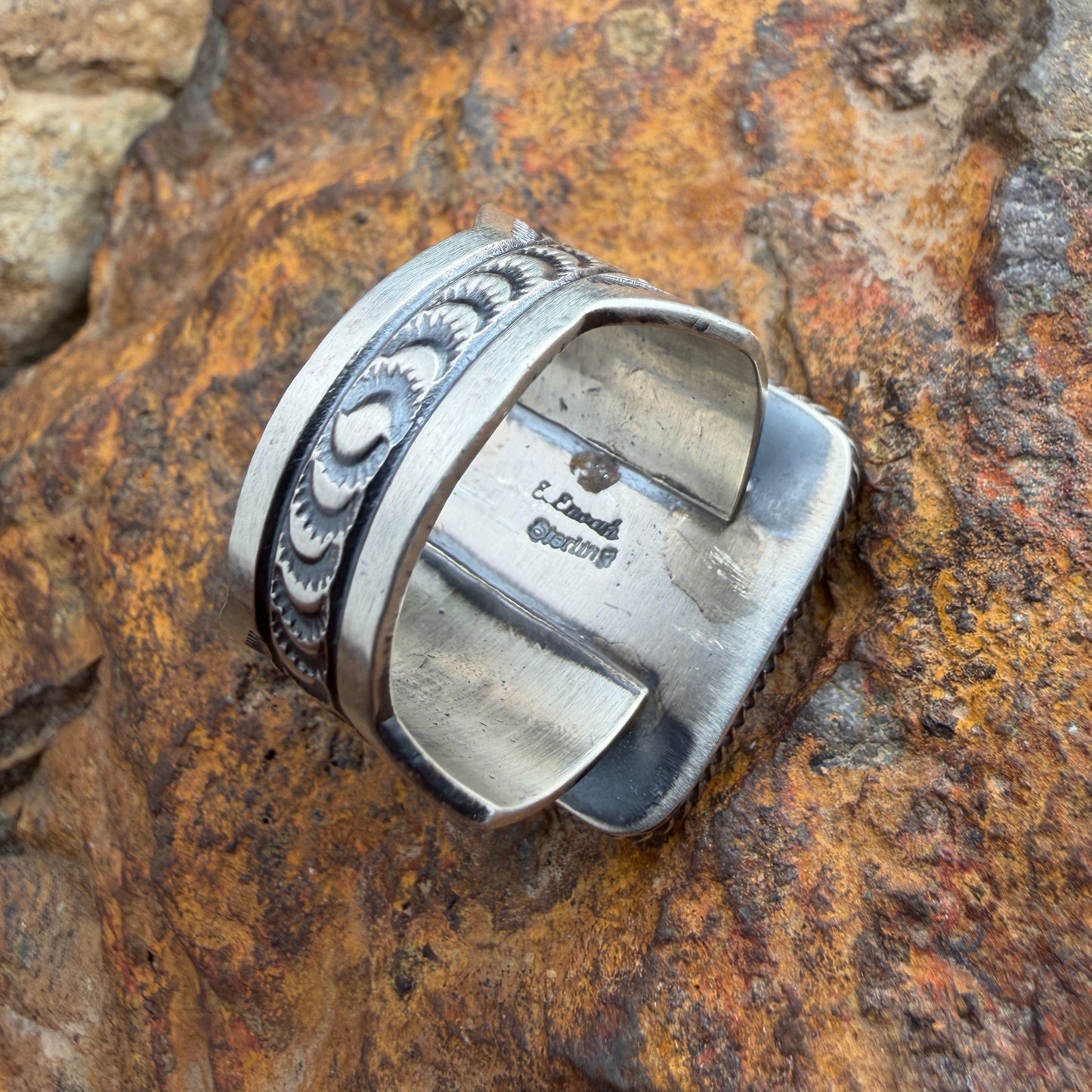Back of a silver ring with stamping on it "Sterling" "E.Enoah"