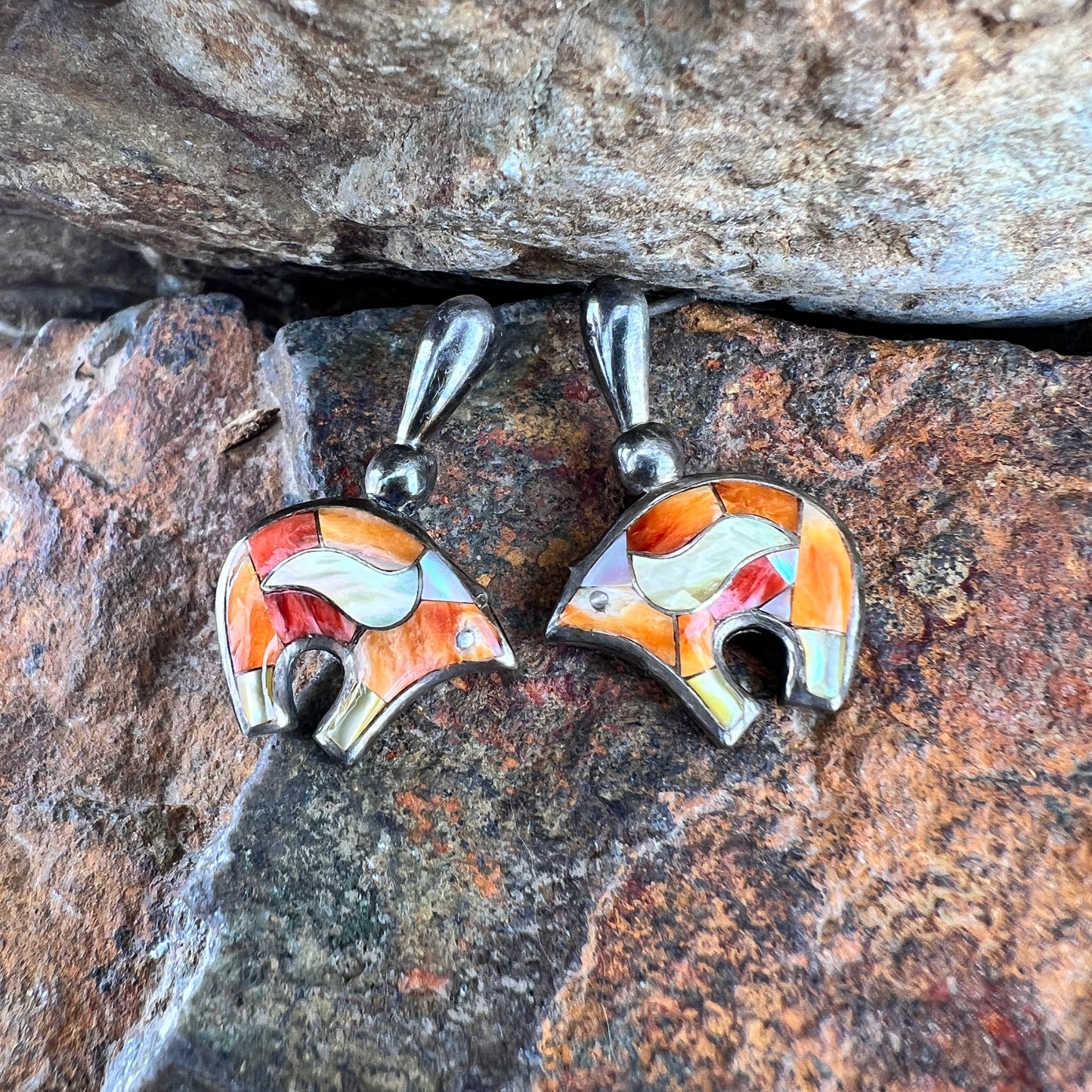 Post earrings that have bears that are inlaid with orange, white, and gold