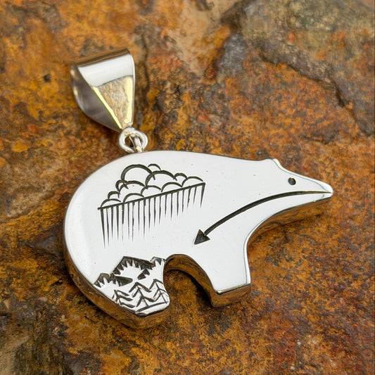 Reversible Sterling Silver Bear Pendant by Norman Woody - side two showing hand-engraved storm clouds with rain, mountain peaks, and heart line arrow