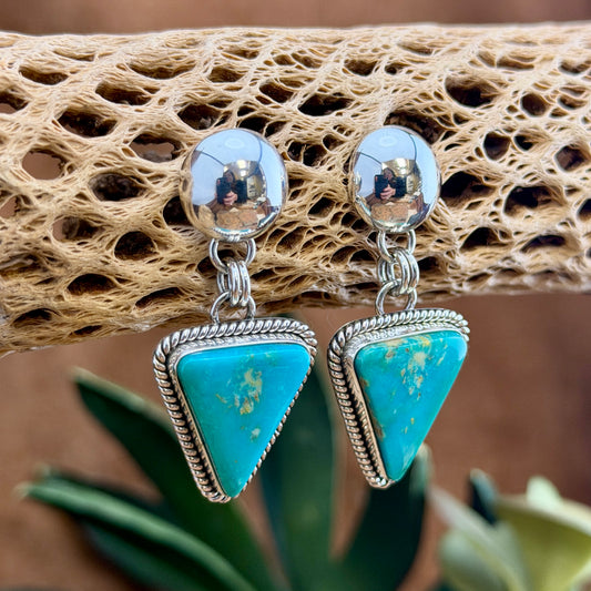 Front of Artie Yellowhorse Kingman turquoise triangle post-drop earrings