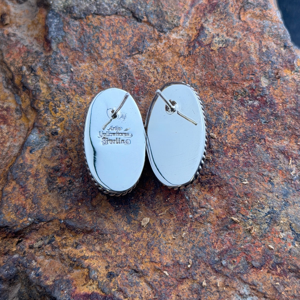 Pair of oval blue lapis lazuli post earrings in sterling silver with twisted-rope borders