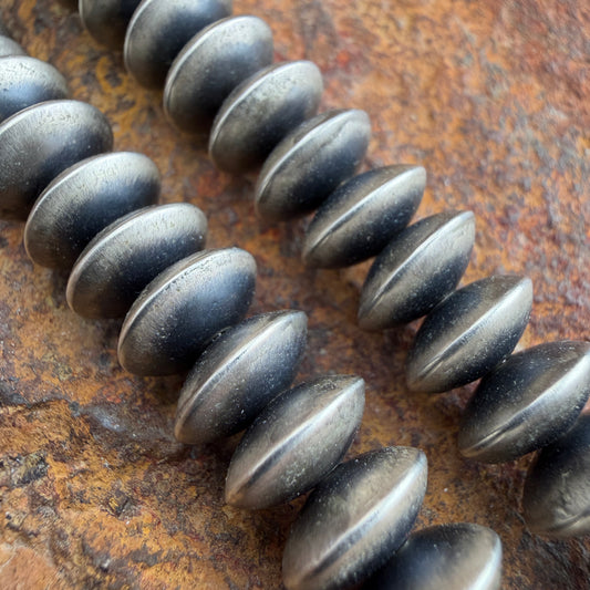Close up of oxidized sterling silver saucer beads