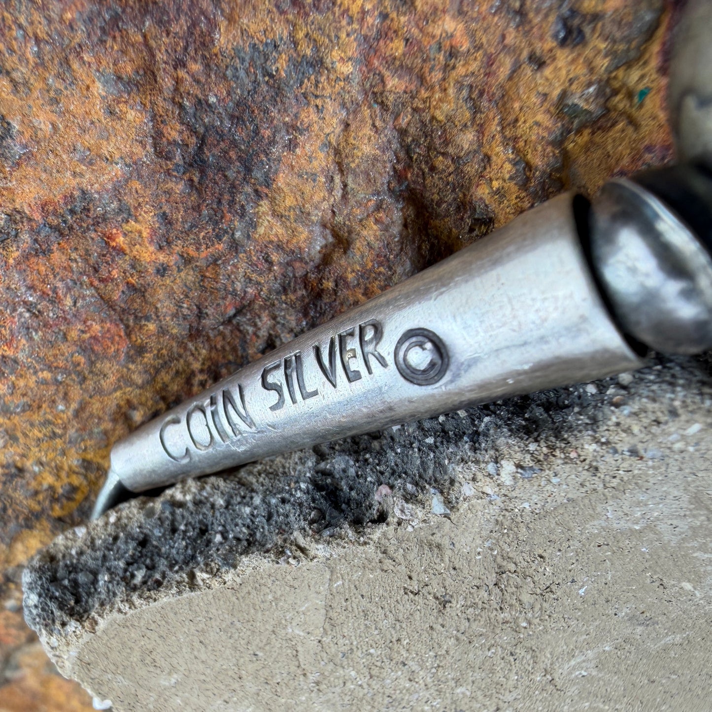 Conical end to a necklace stamped "Coin Silver"