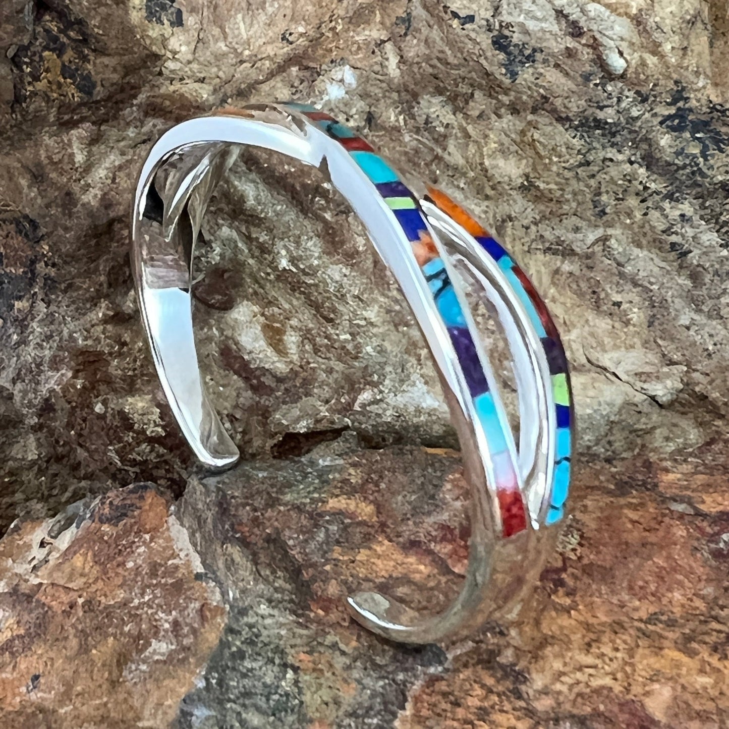 as part of the Indian Summer Collection features Sugilite, Spiny Oyster Shell, Kingman Turquoise, Tibetan Turquoise, Gaspiete and Lapis in a Fancy Inlay Pattern