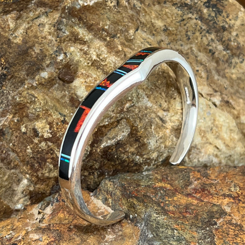 as part of the Red Moon Collection, features a Fancy Inlay pattern of Black Jade, Kingman Turquoise and Blue, Green & Red Cultured Opal.