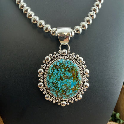 Kingman Turquoise Oval Pendant by Artie Yellowhorse - close-up styled on Navajo pearl necklace showing stone detail