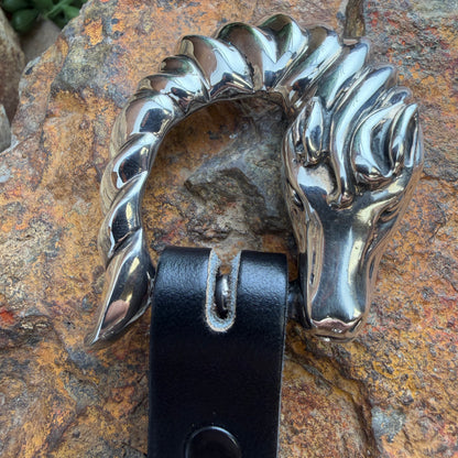 Metallic horse head stirrup on a textured stone background