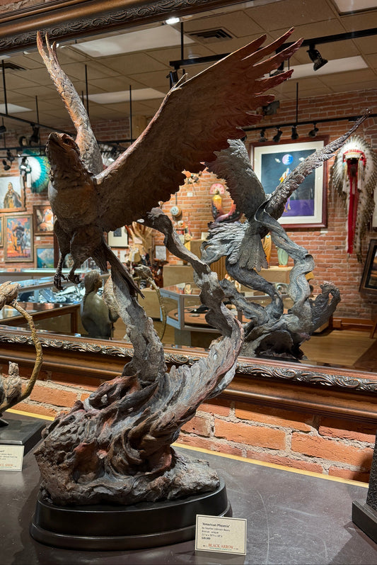 bird in flight on a wood pedestal