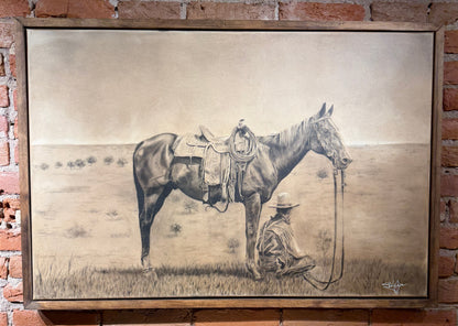 Framed artwork of a horse and a person on a brick wall