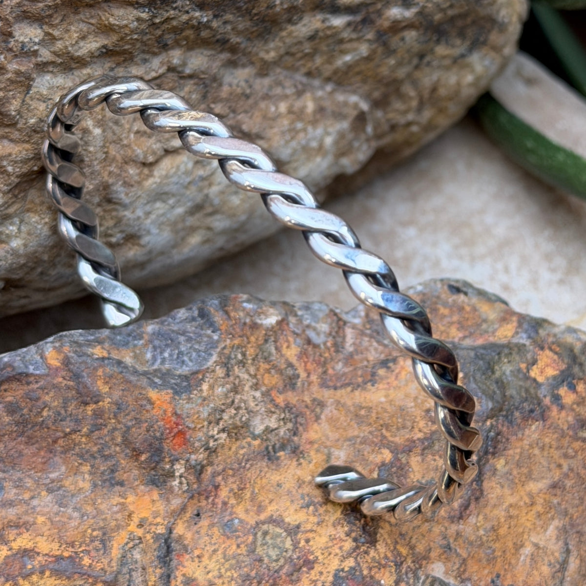 Angled view of Verna Tahe sterling silver braided rope cuff