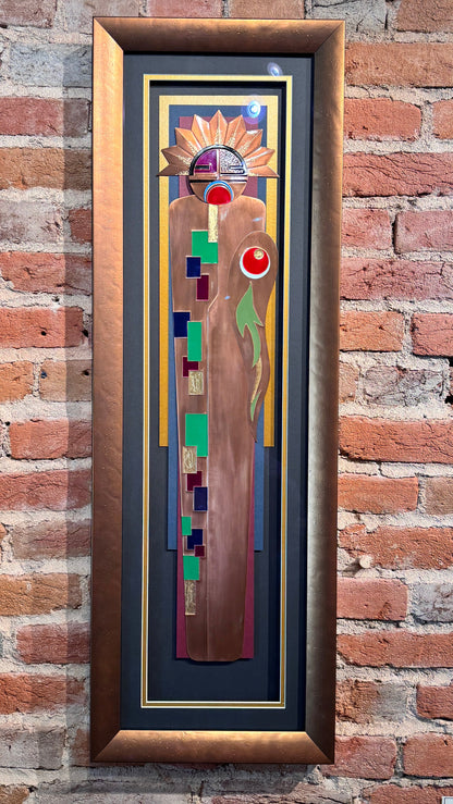 Framed abstract artwork on a brick wall