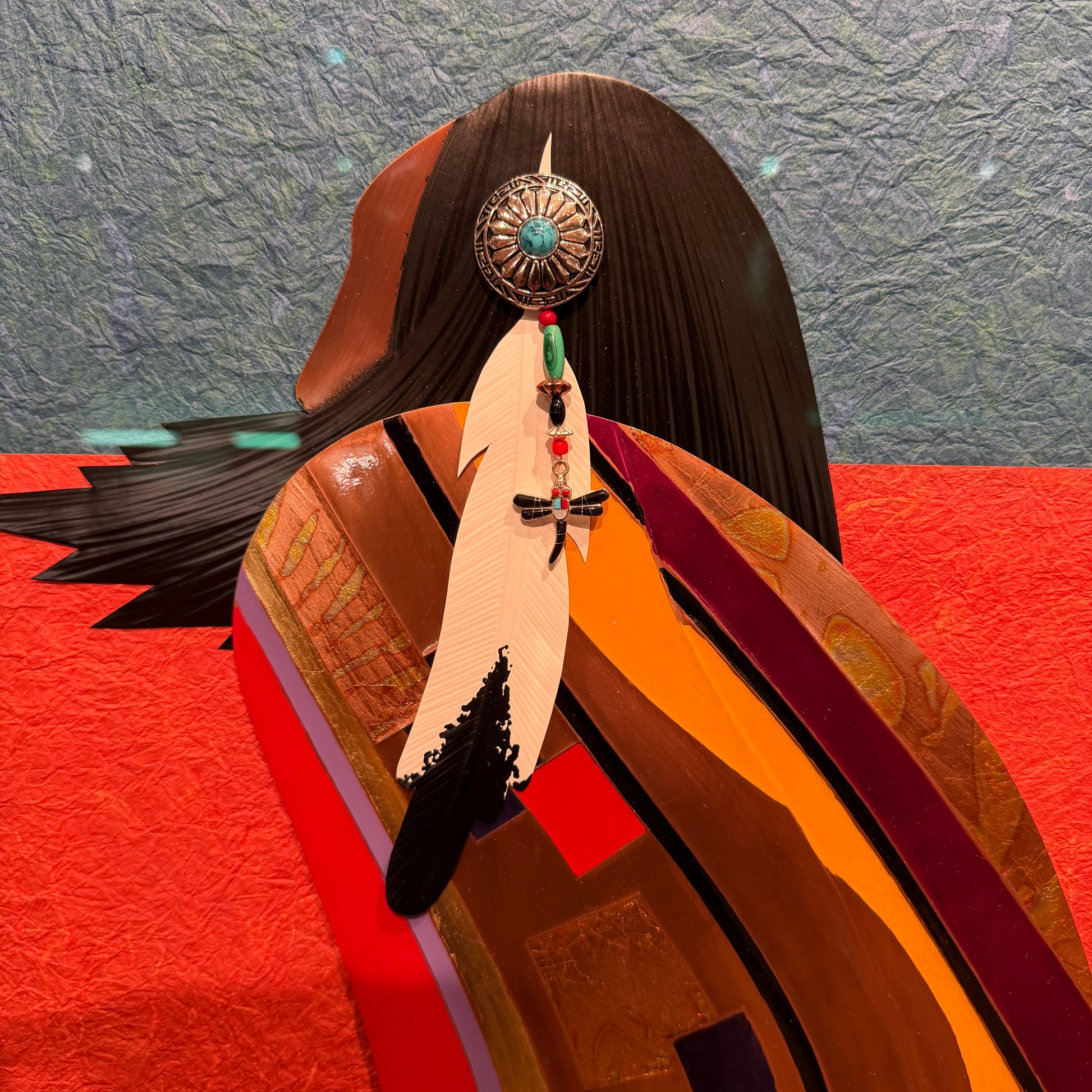 Feathered headdress with decorative elements on a textured background