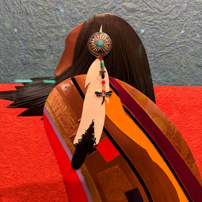 Feathered headdress with decorative elements on a textured background