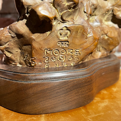 Bronze sculpture with 'Moore' engraving on a wooden base