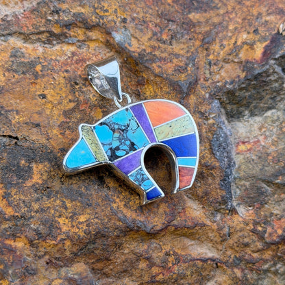 Bear shaped Sterling silver pendant with blue, green, orange, red, purple inlay with raised silver channels.