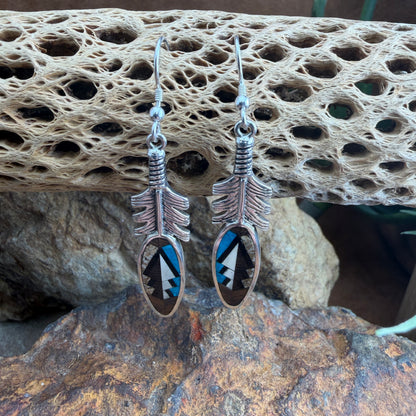 Silver feather-shaped earrings with blue, brown and black designs 