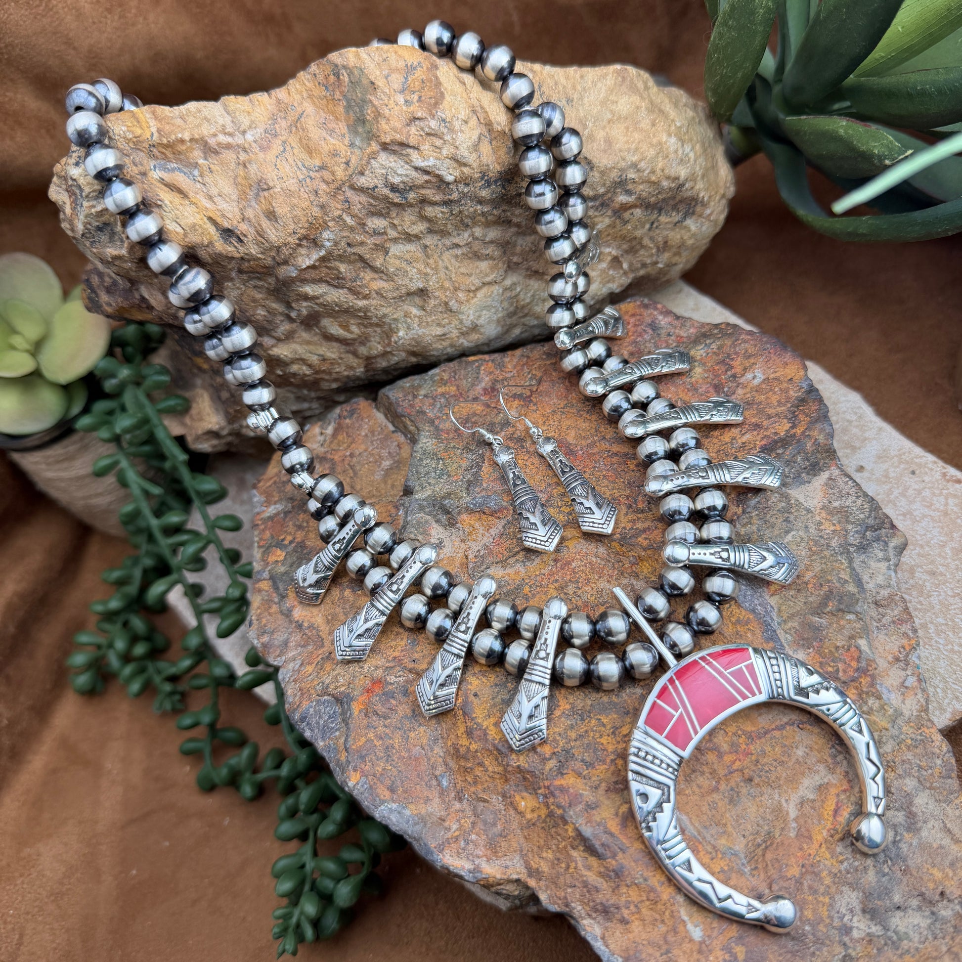  double chained Silver beaded necklace with stamped triangular beads. With silver stamped center piece, inlaid with red