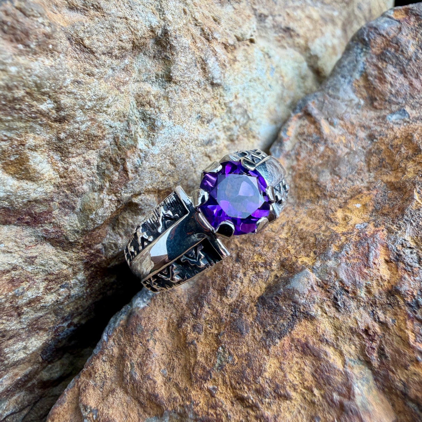 Silver stamp worked ring a purple gemstone 
