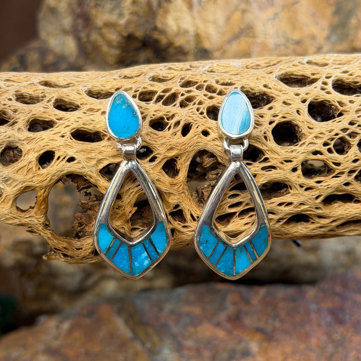 Pair of Sterling Silver Drop Post earrings That feature light blue stone inlay