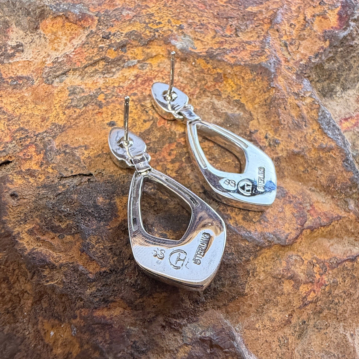 the back of a Pair of Sterling Silver Drop Post Featuring Stamping "SS""Sterling"