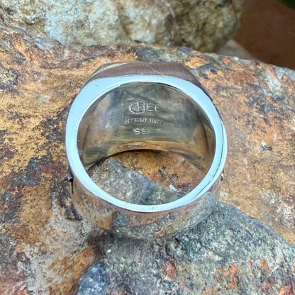 The inside of sterling silver band that features the stamping of the supersmith company, sterling, and the individual artist that worked on this piece.