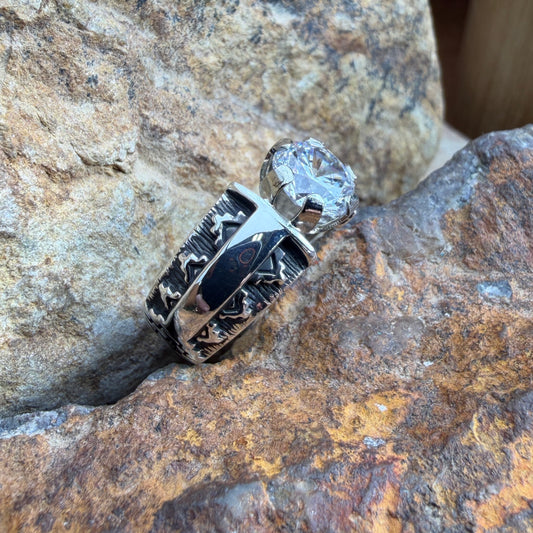 Silver ring with a cubic zirconia on a textured stone surface