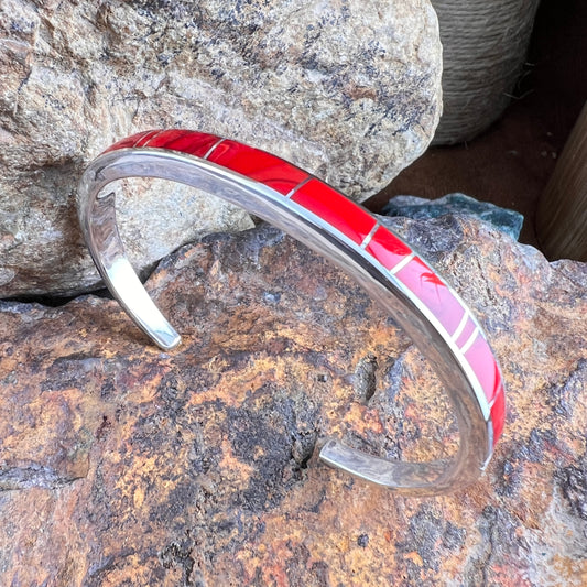 Red and silver bracelet on a textured stone surface