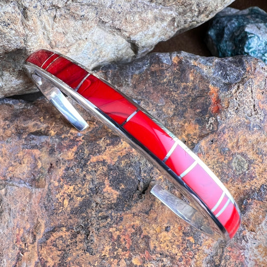 Red inlaid bracelet on a rocky surface