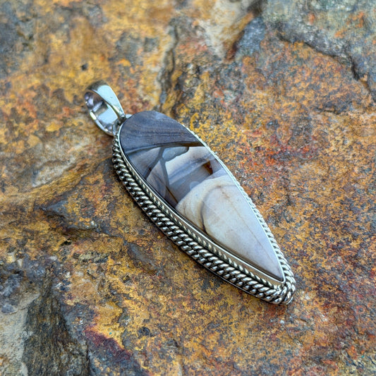 Deschutes Jasper Pendant by Artie Yellowhorse - angled view showing warm tan and charcoal landscape banding in twisted rope setting