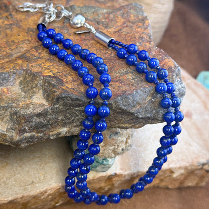 Close view of round vivid-blue lapis beads and small faceted blue spacers