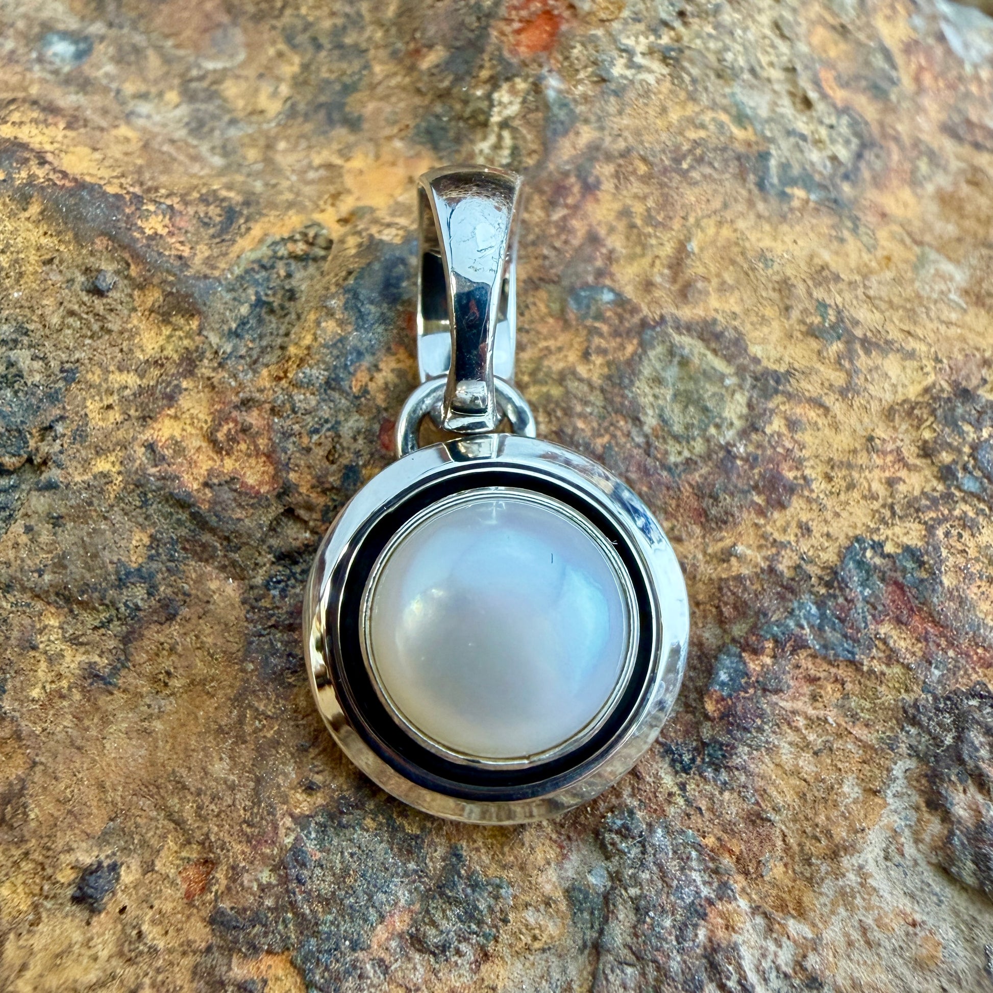 Sterling Silver Freshwater Pearl Pendant by Artie Yellowhorse - straight front view showing luminous pearl and polished silver surround