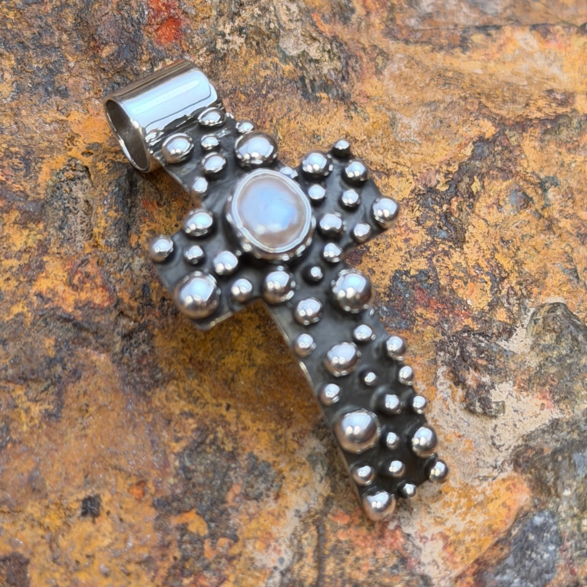 Reverse of freshwater pearl cross pendant with A. Douglas hallmark