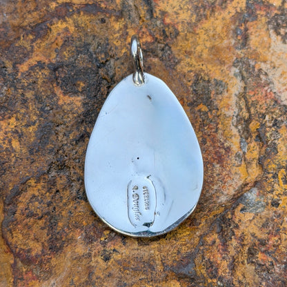 Oblong Sterling Silver Pendant decorated by silverbeads, a freshwater pearl and a cross by a douglas