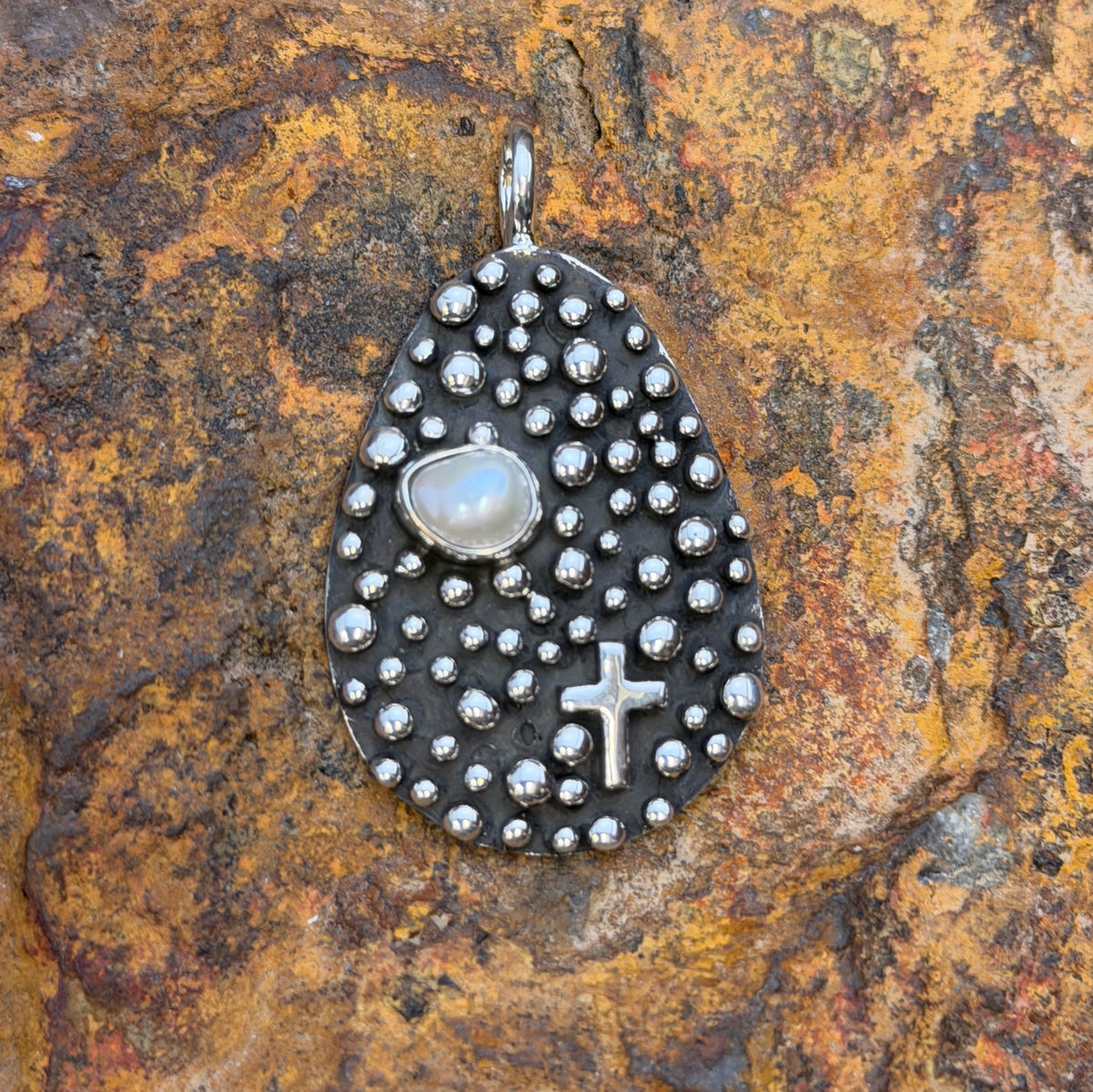 Oblong Sterling Silver Pendant decorated by silverbeads, a freshwater pearl and a cross by a douglas