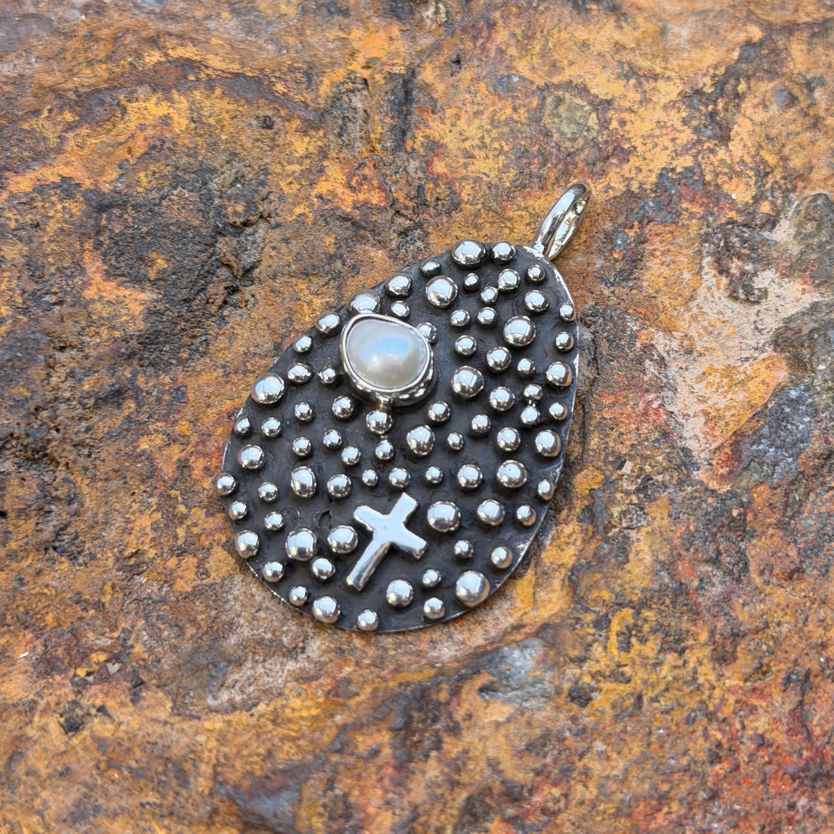 Oblong Sterling Silver Pendant decorated by silverbeads, a freshwater pearl and a cross by a douglas