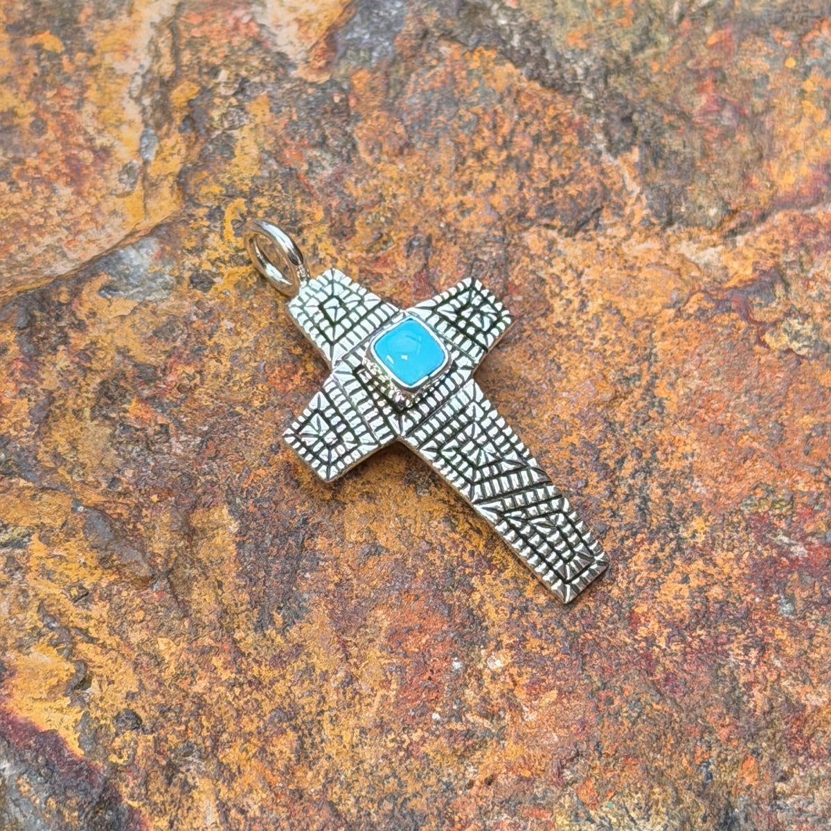 Sleeping Beauty turquoise cross pendant by Elgin Tom, angled view