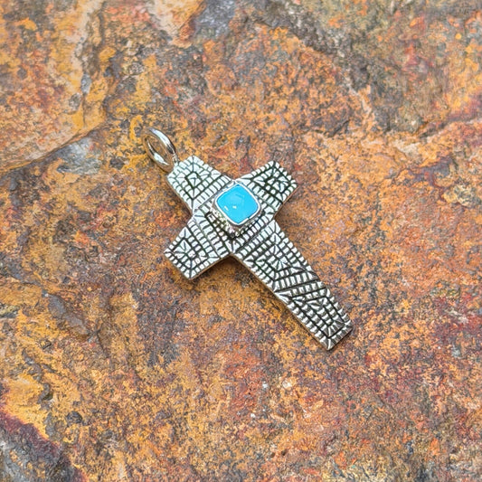 Sleeping Beauty turquoise cross pendant by Elgin Tom, angled view
