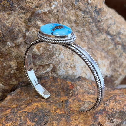 Front view of Golden Hills turquoise cuff bracelet with oval bezel-set stone and rope silverwork