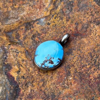 A light blue golden hills turquoise pendant with chocolate matrix by angela martin. 
