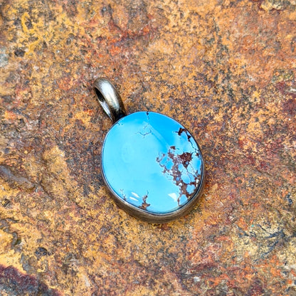 A light blue golden hills turquoise pendant with chocolate matrix by angela martin. 