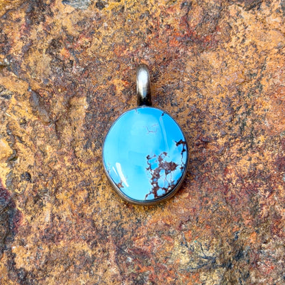A light blue golden hills turquoise pendant with chocolate matrix by angela martin. 