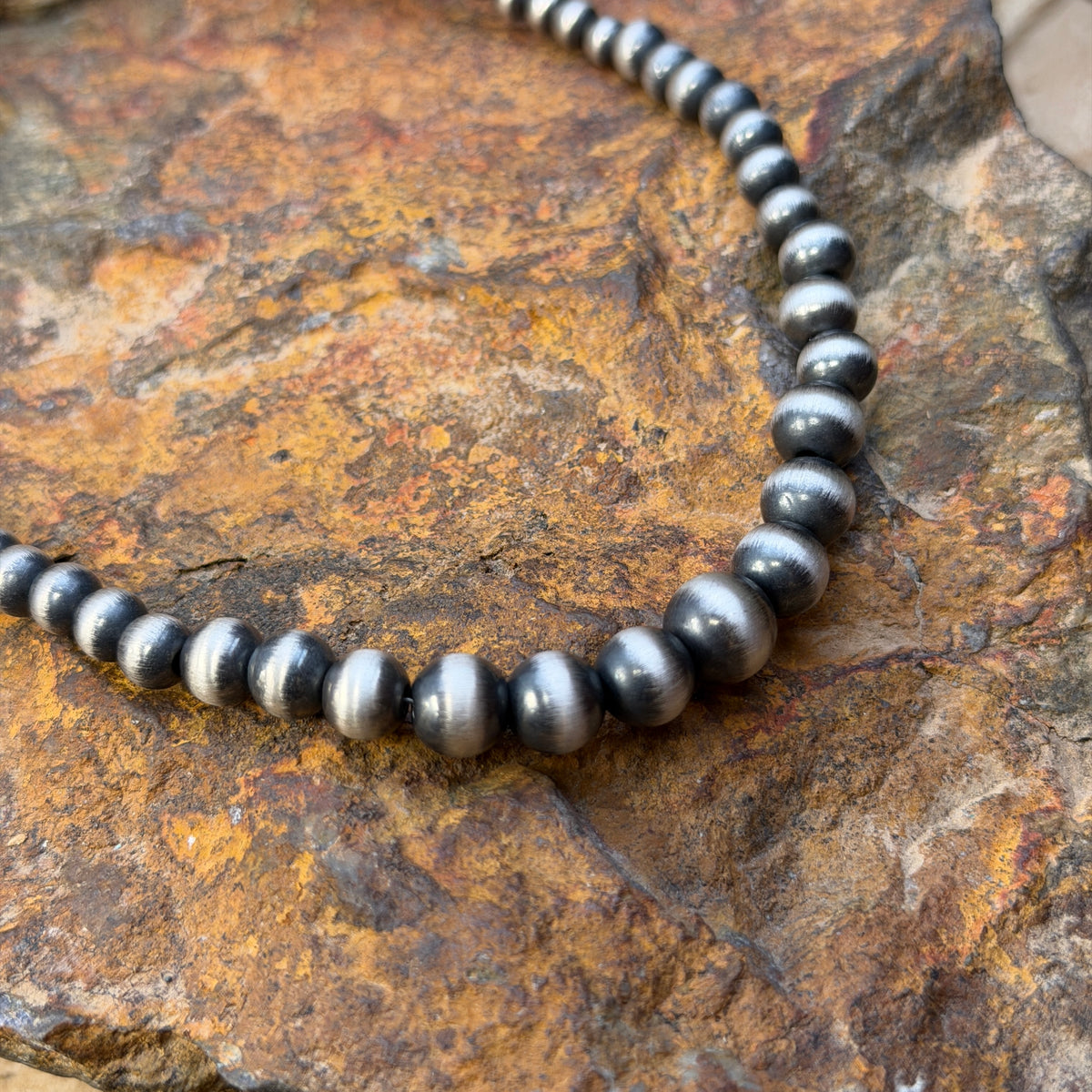 Close-up of graduated Navajo pearl beads increasing toward the center