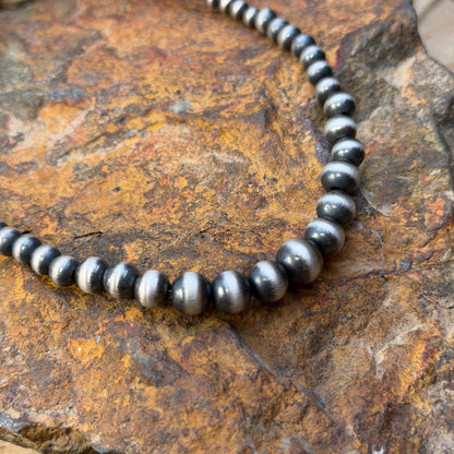 Close-up of graduated Navajo pearl beads increasing toward the center