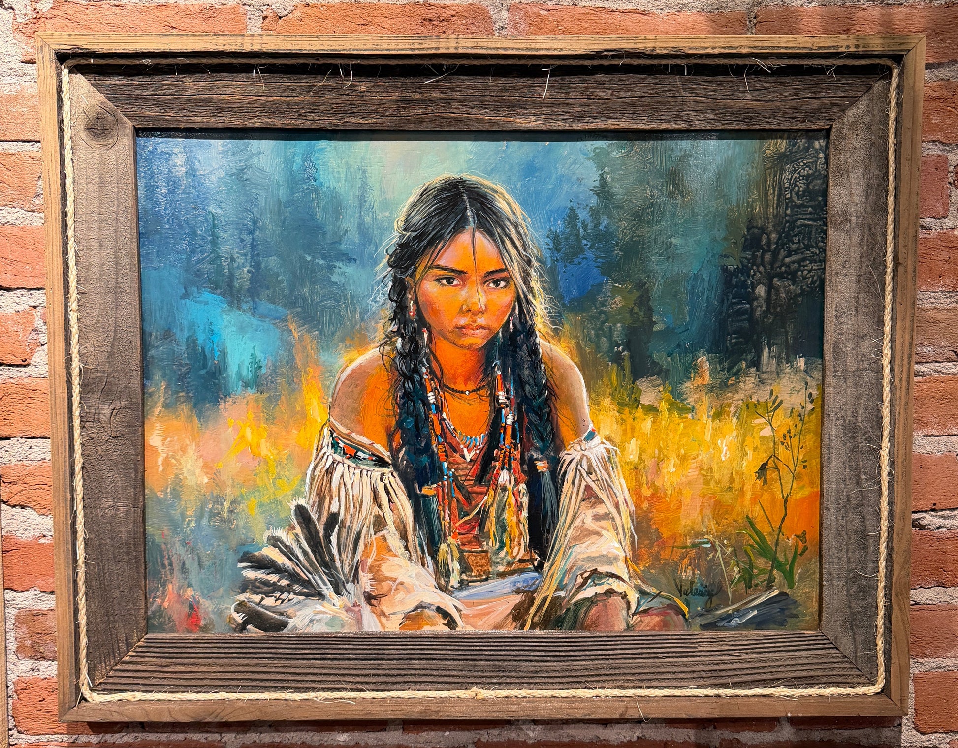 Painting of a woman with long hair and traditional attire on a brick wall.