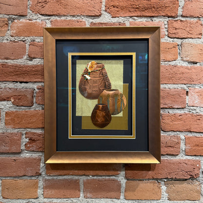 An art piece that contains thinly pressed copper shaped and detailed to represent three traditional Native American ceramic pots. They are placed in the foreground. The background is light green and gold. Framed in a copper-colored frame.