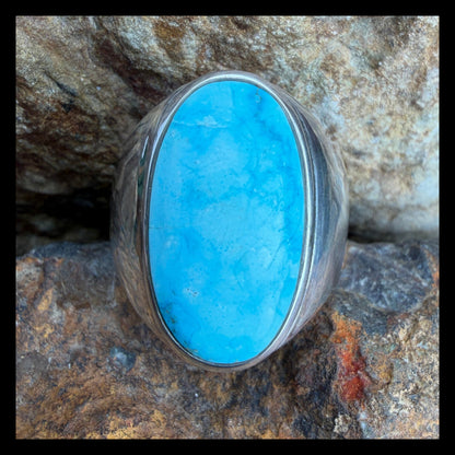 Turquoise stone ring on a rocky surface