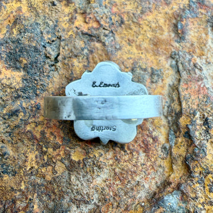 Back of a silver ring with stamping on it. "Sterling" and "E. Enoah"